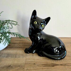Vintage Mid Century Modern ceramic black cat sculpture with glass green eyes.